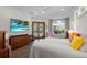 Bright main bedroom boasts hardwood floors, a ceiling fan, and a view of the pool from a set of windows at 11401 Willow Stowe Ln, Windermere, FL 34786