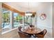 Cozy breakfast nook with backyard pool views, stylish lighting, and a round table at 11401 Willow Stowe Ln, Windermere, FL 34786