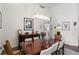 Dining room featuring hardwood floors, contemporary lighting fixture, and a view down a hallway at 11401 Willow Stowe Ln, Windermere, FL 34786