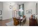 Elegant dining room with hardwood floors, modern lighting, and stylish decor at 11401 Willow Stowe Ln, Windermere, FL 34786
