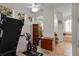 Well-lit workout area featuring travertine tile, exercise equipment, and an adjacent bathroom at 11401 Willow Stowe Ln, Windermere, FL 34786