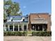 Charming commercial building with a blue metal roof next to Windermere Brewing Company at 11401 Willow Stowe Ln, Windermere, FL 34786
