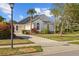Charming single-story home boasting lush landscaping, a well-manicured lawn, and inviting curb appeal on a sunny day at 11401 Willow Stowe Ln, Windermere, FL 34786