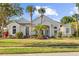 Charming single Gathering home with lush landscaping, palm trees, and a well-maintained lawn at 11401 Willow Stowe Ln, Windermere, FL 34786