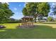 Wooden gazebo set on a grassy lawn offers a relaxing community gathering place with landscaping at 11401 Willow Stowe Ln, Windermere, FL 34786