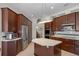 Modern kitchen featuring stainless steel appliances, central island, and dark wood cabinetry at 11401 Willow Stowe Ln, Windermere, FL 34786