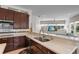 Kitchen with an open layout overlooking living area and featuring a breakfast bar and quartz countertops at 11401 Willow Stowe Ln, Windermere, FL 34786
