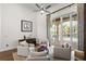Cozy seating area with ceiling fan and sliders to the pool and lanai at 11401 Willow Stowe Ln, Windermere, FL 34786