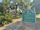 Community park sign with park hours and regulations, set within a lush green space at 11401 Willow Stowe Ln, Windermere, FL 34786