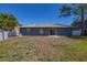 Wide shot of the backyard with a storage shed, patio, and an exterior view of the home at 1153 Perpignan Ct, Kissimmee, FL 34759