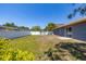 Fenced backyard featuring a shed, with sliding glass doors leading to the patio at 1153 Perpignan Ct, Kissimmee, FL 34759
