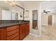 Bathroom featuring wood cabinets, a granite countertop, and tile flooring at 1153 Perpignan Ct, Kissimmee, FL 34759