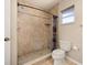 Bathroom featuring a tiled walk-in shower with a rainfall showerhead and a modern toilet at 1153 Perpignan Ct, Kissimmee, FL 34759