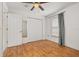 Cozy bedroom showcasing wood floors, a ceiling fan, closet, and a window at 1153 Perpignan Ct, Kissimmee, FL 34759