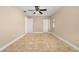Spacious bedroom with tile floors, a ceiling fan, and two closets for ample storage space at 1153 Perpignan Ct, Kissimmee, FL 34759