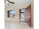 Inviting entryway with a red front door, tile flooring, and a view of the front porch at 1153 Perpignan Ct, Kissimmee, FL 34759