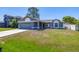 Charming single-story home with a well-manicured lawn and attached garage at 1153 Perpignan Ct, Kissimmee, FL 34759