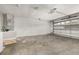 Spacious garage with block walls, concrete floor, and garage door with windows at 1153 Perpignan Ct, Kissimmee, FL 34759