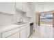 Modern kitchen with plenty of storage and a view to the backyard through sliding glass doors at 1153 Perpignan Ct, Kissimmee, FL 34759
