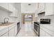Well-lit kitchen featuring sleek appliances, white cabinets, and sliding glass doors to the backyard at 1153 Perpignan Ct, Kissimmee, FL 34759