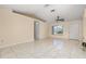 Bright living room featuring tile floors, a ceiling fan, and a large window for plenty of natural light at 1153 Perpignan Ct, Kissimmee, FL 34759