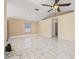 Expansive living room with tile flooring and a neutral color palette, perfect for relaxation and entertainment at 1153 Perpignan Ct, Kissimmee, FL 34759