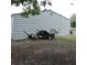 A well-kept backyard featuring a trailer next to the shed, which offers space and functionality at 1160 Rolling Acres Dr, Deland, FL 32720