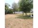An expansive backyard is surrounded by mature trees and newer fencing at 1160 Rolling Acres Dr, Deland, FL 32720