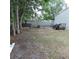 View of the backyard area with a small trailer and the side of the shed at 1160 Rolling Acres Dr, Deland, FL 32720
