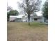 View of the backyard with the house and shed, creating a serene and private outdoor haven at 1160 Rolling Acres Dr, Deland, FL 32720