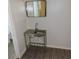 Bathroom area with metal wash basin, small mirror and view into the bathroom at 1160 Rolling Acres Dr, Deland, FL 32720