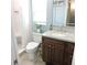 Bright bathroom with a marble vanity, under sink storage, and a tile-lined shower with seat at 1160 Rolling Acres Dr, Deland, FL 32720