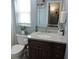 Charming bathroom featuring a vanity with marble countertop and a decorative mirror and lighting at 1160 Rolling Acres Dr, Deland, FL 32720