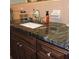 Bathroom featuring granite countertop and dark brown vanity at 1160 Rolling Acres Dr, Deland, FL 32720