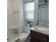 Modern bathroom featuring a walk-in shower with bench and a vanity with granite countertop at 1160 Rolling Acres Dr, Deland, FL 32720