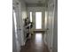 Bright entryway featuring wood-look tile, a white door, and decorative accents on shelves at 1160 Rolling Acres Dr, Deland, FL 32720