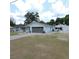 The well-maintained home exterior has a long driveway and tidy landscaping at 1160 Rolling Acres Dr, Deland, FL 32720