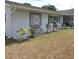 Landscaped front of house with a bench, an architectural medallion, and multiple potted plants adding character to the property at 1160 Rolling Acres Dr, Deland, FL 32720