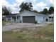 This cozy home has a gray garage door and tidy front yard at 1160 Rolling Acres Dr, Deland, FL 32720