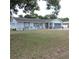 Charming home exterior boasts a well-manicured lawn and landscaping at 1160 Rolling Acres Dr, Deland, FL 32720