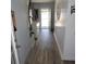 Hallway with tiled walls, wood look floors, and access to the exterior of the home at 1160 Rolling Acres Dr, Deland, FL 32720