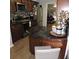 Stylish kitchen showcasing granite countertops, stainless steel appliances, and dark wood cabinetry at 1160 Rolling Acres Dr, Deland, FL 32720