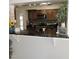 Pass-through kitchen with dark wood cabinets and granite countertops at 1160 Rolling Acres Dr, Deland, FL 32720