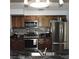 This kitchen is equipped with modern stainless steel appliances and wood cabinets at 1160 Rolling Acres Dr, Deland, FL 32720