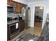 A functional kitchen with stainless steel appliances and dark wood cabinets at 1160 Rolling Acres Dr, Deland, FL 32720