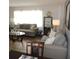 Comfortable living room with neutral gray sofas, glass coffee table, and display cabinet at 1160 Rolling Acres Dr, Deland, FL 32720