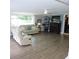 Inviting living room with a fireplace, ceiling fan, tile flooring, and plenty of natural light at 1160 Rolling Acres Dr, Deland, FL 32720