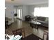 Cozy living room showcasing wood-look tile, a comfy sofa, and access to the front door at 1160 Rolling Acres Dr, Deland, FL 32720