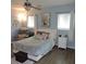 Relaxing main bedroom boasts a ceiling fan, a cozy sitting chair and a neutral color palette at 1160 Rolling Acres Dr, Deland, FL 32720