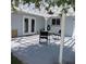 Covered patio with table, chairs and an outdoor fan hanging from the ceiling at 1160 Rolling Acres Dr, Deland, FL 32720